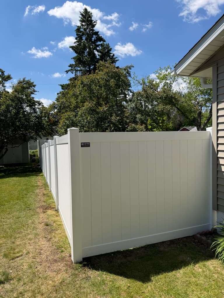 White vinyl privacy fence installation in the Chippewa Valley
