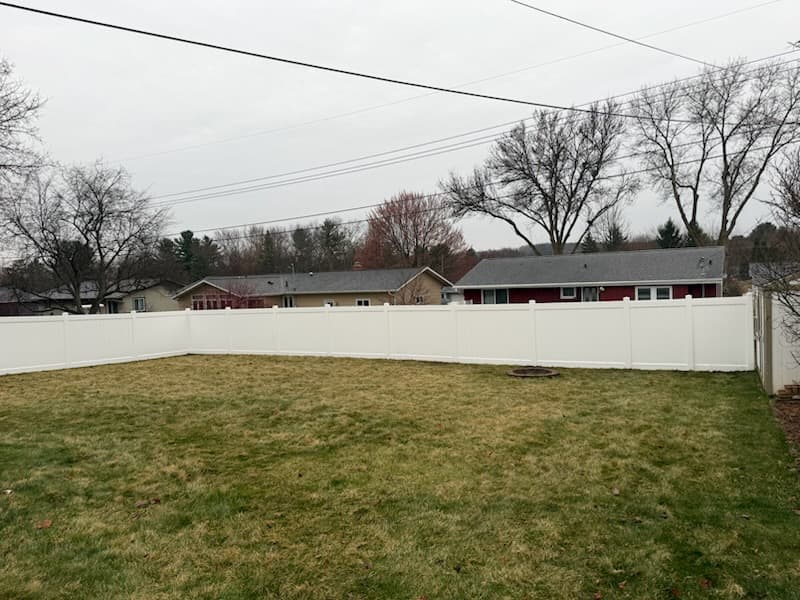 White vinyl privacy fence installation in the Chippewa Valley
